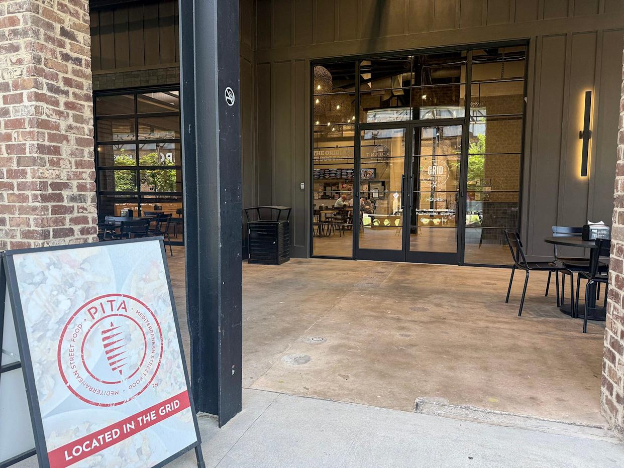 A sign for Pita Mediterranean Street Food restaurant marks the entrance to The Grid food court area of Wire Park in Watkinsville, Ga., on Tuesday, April 14, 2026.