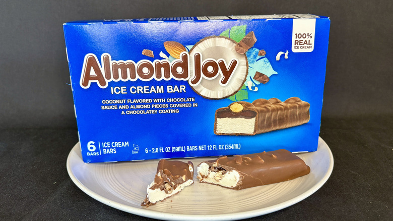 Almond Joy ice cream bar cut open on plate with box in background