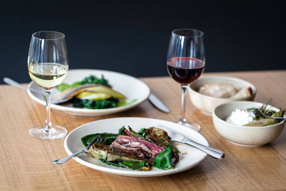italian food on plates with glasses of wine