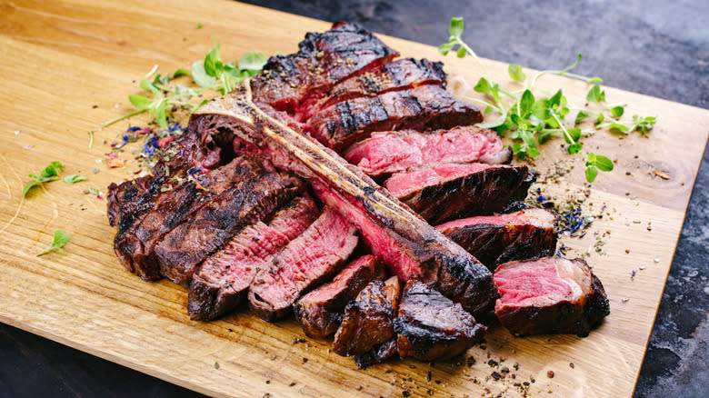 A sliced bistecca alla fiorentina steak on a cutting board