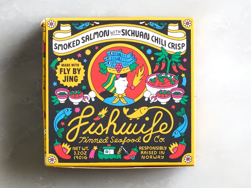 Colorful packaging for Fishwife smoked salmon with Sichuan chili crisp, featuring illustrations of fish, chili peppers, and bowls.