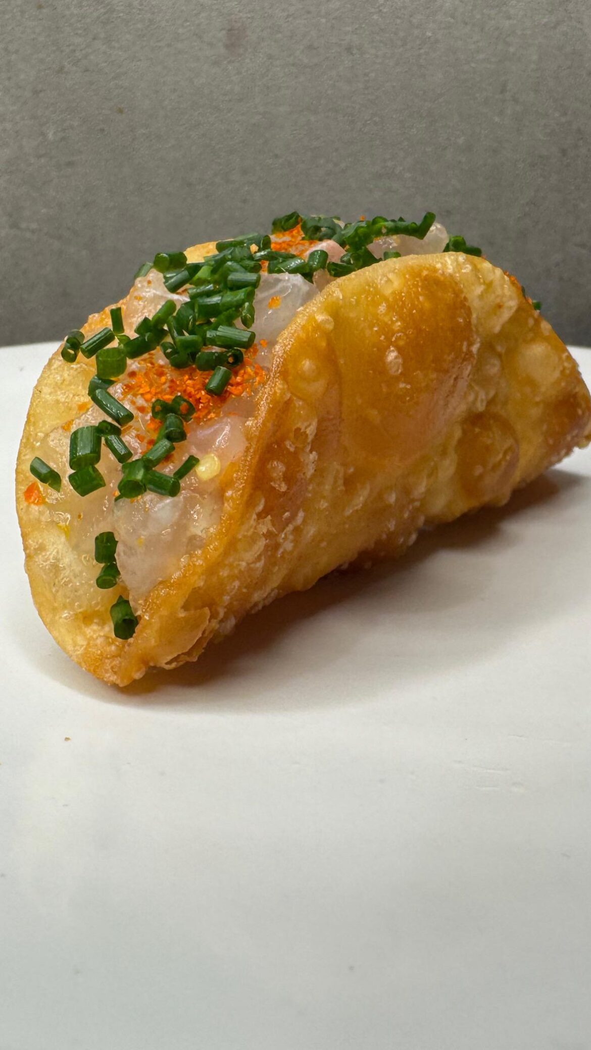 Bream Crudo with yuzu kosho, Togarashi and chives in crispy wonton