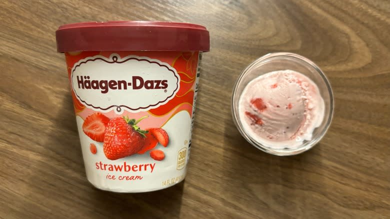 Häagen-Dazs Strawberry Ice Cream carton next to ice cream in glass ramekin