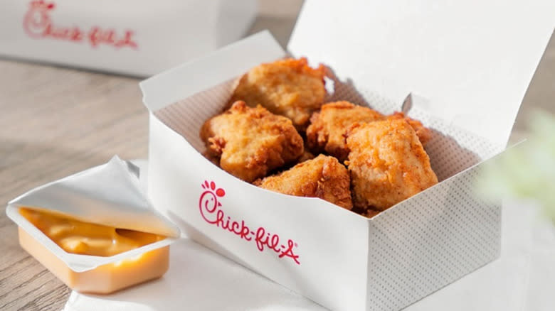 A box of Chick-fil-A nuggets with dipping sauce