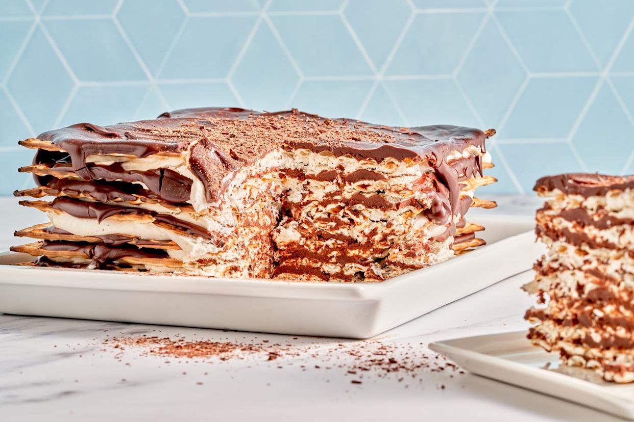 matzoh icebox cake on a white plate with a blue background