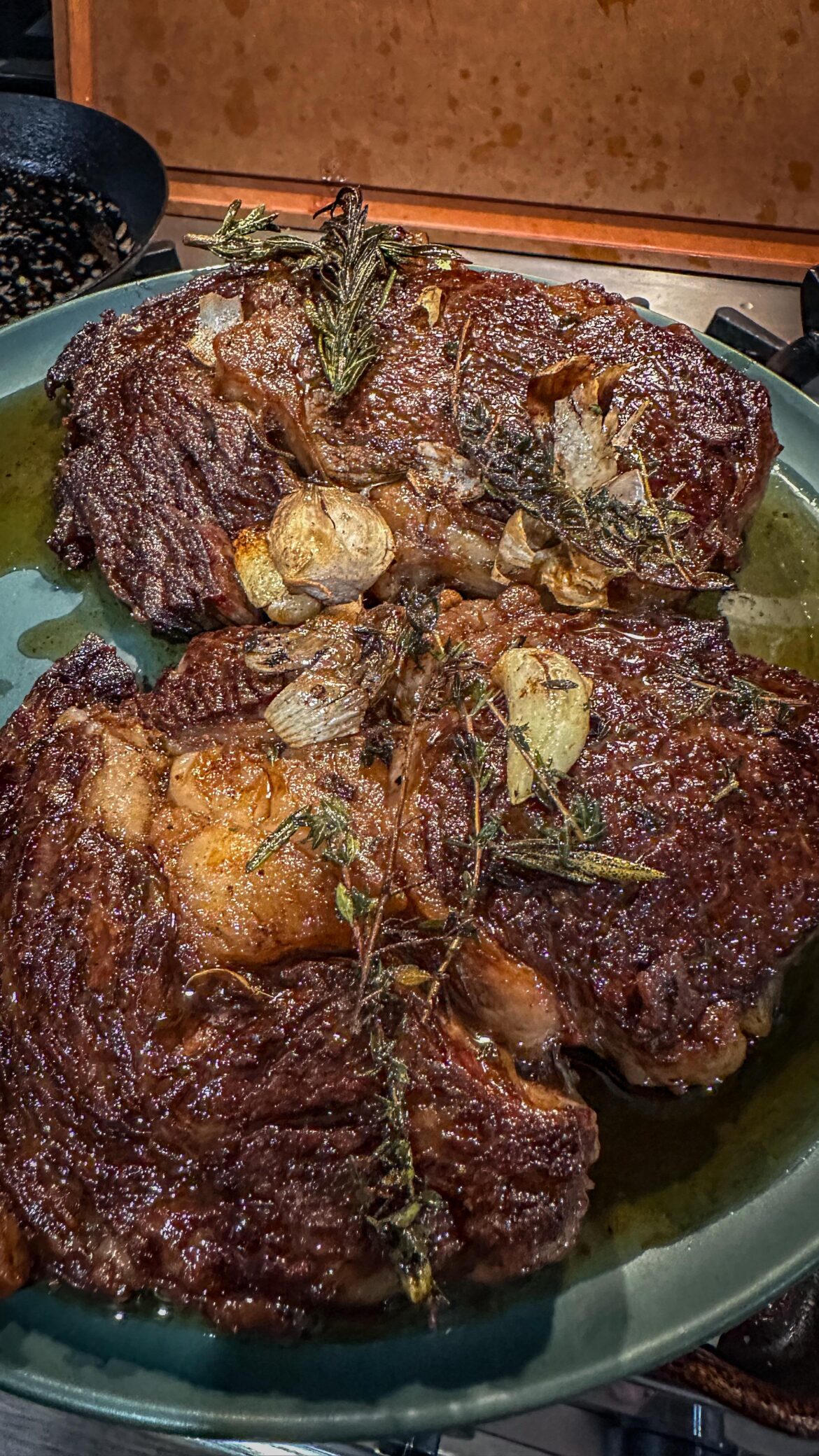 Ribeyes, garlic, herbs, butter, cast iron.