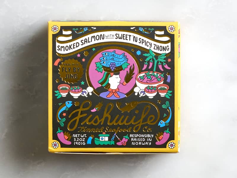 Colorful packaging for smoked salmon with sweet and spicy zhong, featuring illustrations of fish, peppers, and bowls.