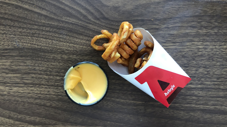 Order of Arby's curly fries with cheese sauce.