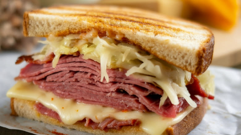 A classic Reuben sandwich piled high with corned beef and sauerkraut