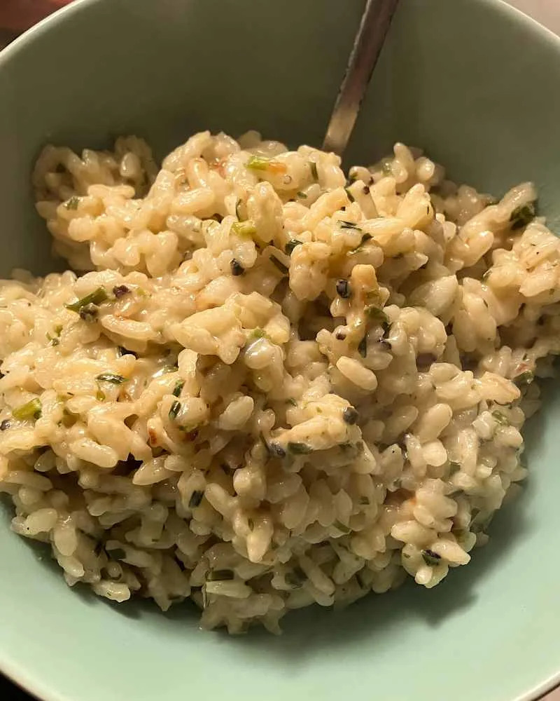 Black pepper and goat cheese risotto in bowl.