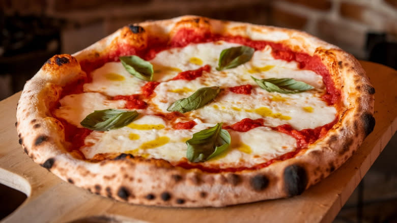 Traditional margherita pizza with basil and olive oil