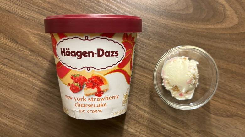 Häagen-Dazs New York Strawberry Cheesecake Ice Cream carton next to ice cream in glass ramekin