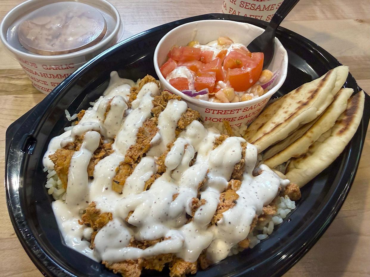 A chicken shawarma platter with pita bread and garbanzo salad at Pita Mediterranean Street Food restaurant inside The Grid food court area of Wire Park in Watkinsville, Ga., on Tuesday, April 14, 2026.