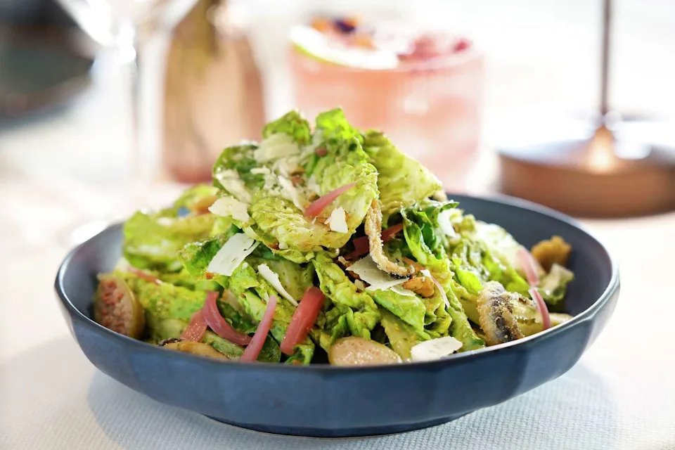 The Green Goddess Caesar Salad is made with Gem lettuce, parmigiano, crispy anchovies, pistachio and pickled red onion at Alara in Dallas. (Tom Fox/The Dallas Morning News)