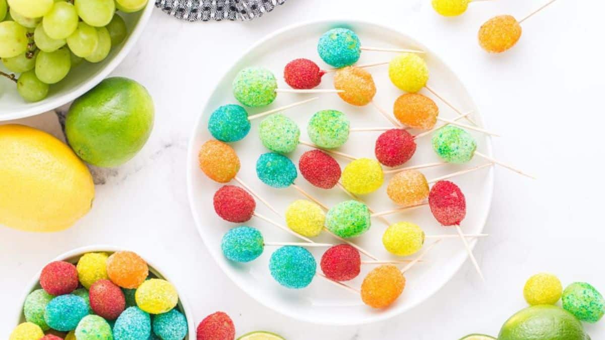 A few pieces of candy grapes  served on a plate. 