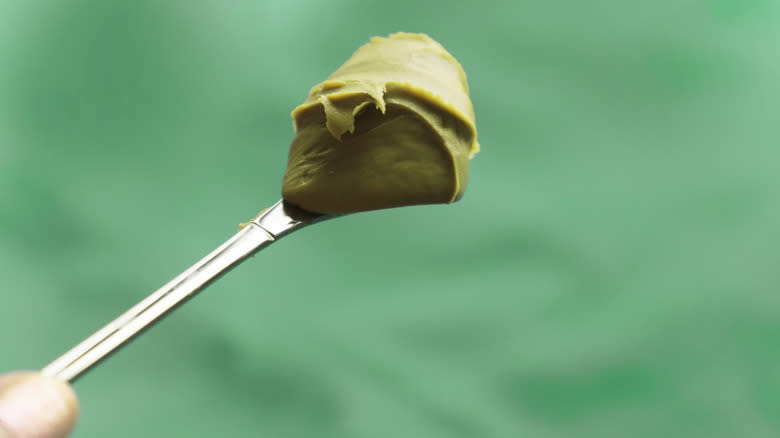Pat of pistachio butter on the end of a butter knife