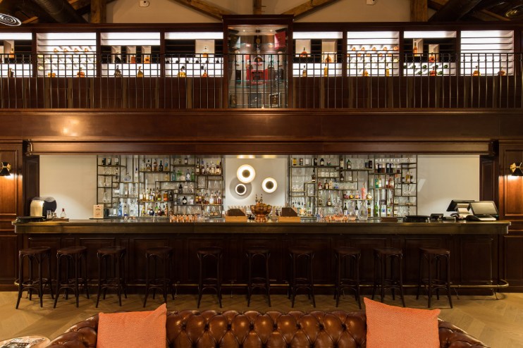 Elegant interior of Bar 1838 at Hotel Chais Monnet Spa showcasing sophisticated decor and ambient lighting.