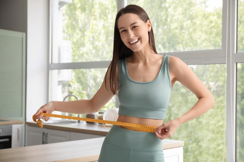 Beautiful Young Fit Happy Woman With Measuring Tape