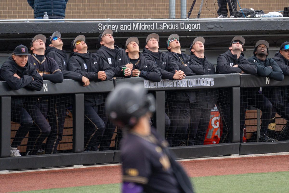 A baseball player wearing black runs with his mouth open and arms outstretched.