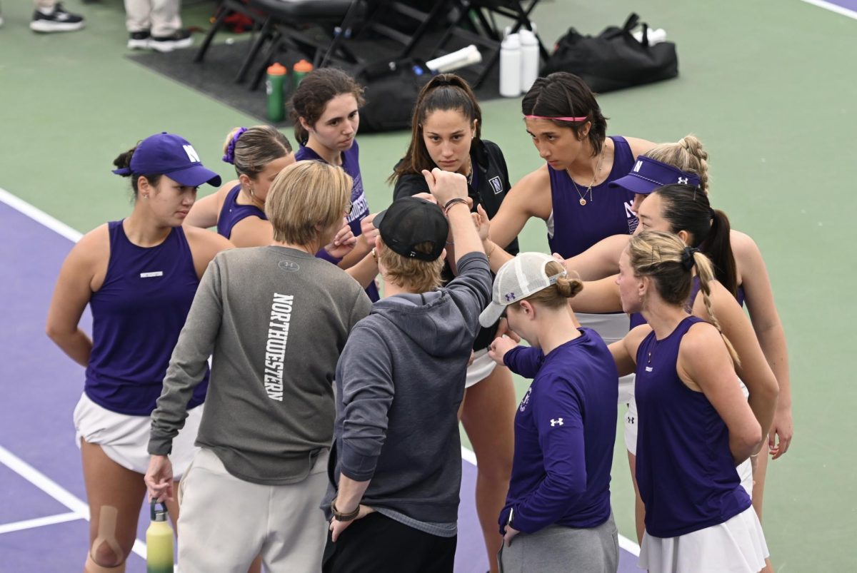 Tennis players and two coaches making a huddle. 