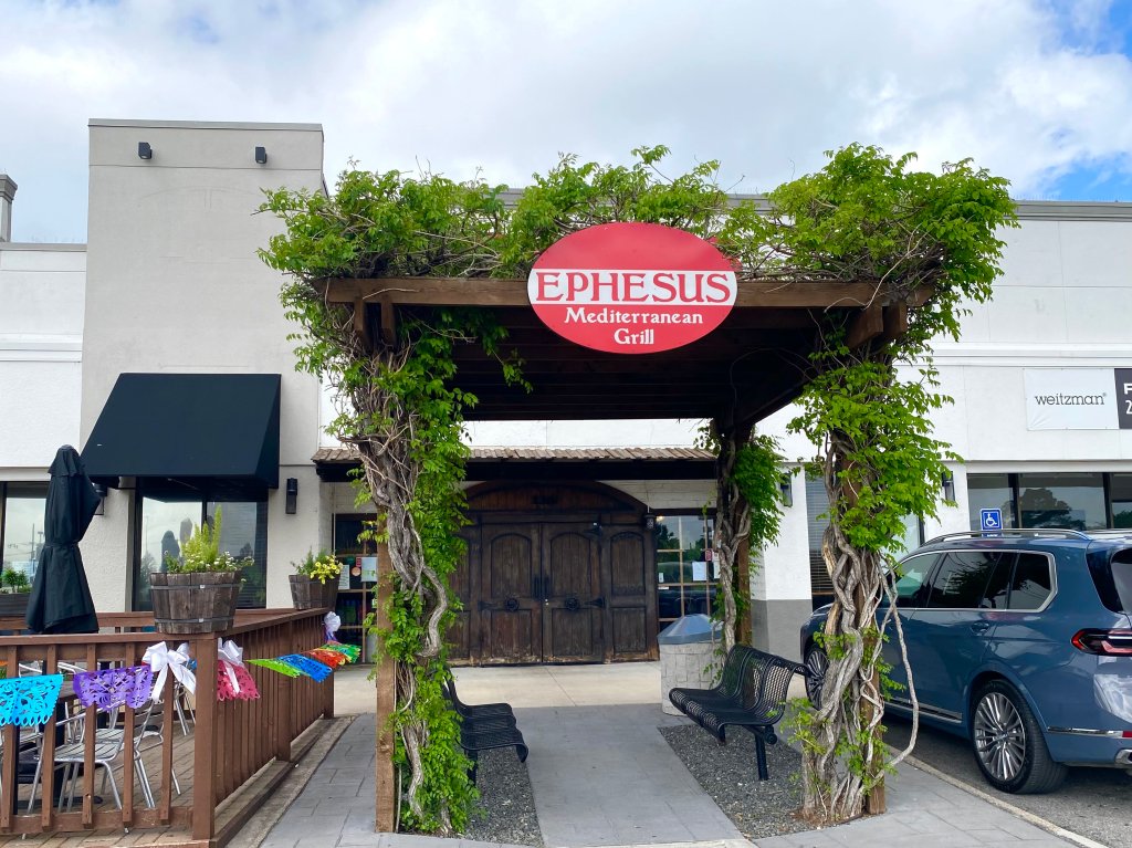 The entrance to Ephesus has a wooden awning covered in vines.