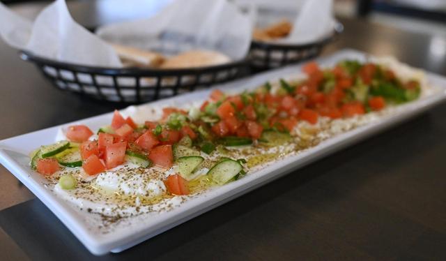 The appetizer Labneh is seen, withchopped tomatoes, cucumbers, jalapenos, onion and green olives on a bed of yogurt at Tete’s Kitchen, serving up Mediterranean food at the corner of Pollasky Avenue and 4th Street. Photographed Thursday, July 10, 2025 in Clovis.