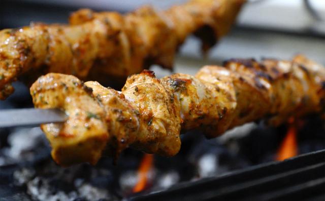 Skewers of Chicken Kabob are grilled over flame at Tete’s Kitchen serving up Mediterranean food at the corner of Pollasky Avenue and 4th Street in Old Town Clovis. Photographed Thursday, July 10, 2025.