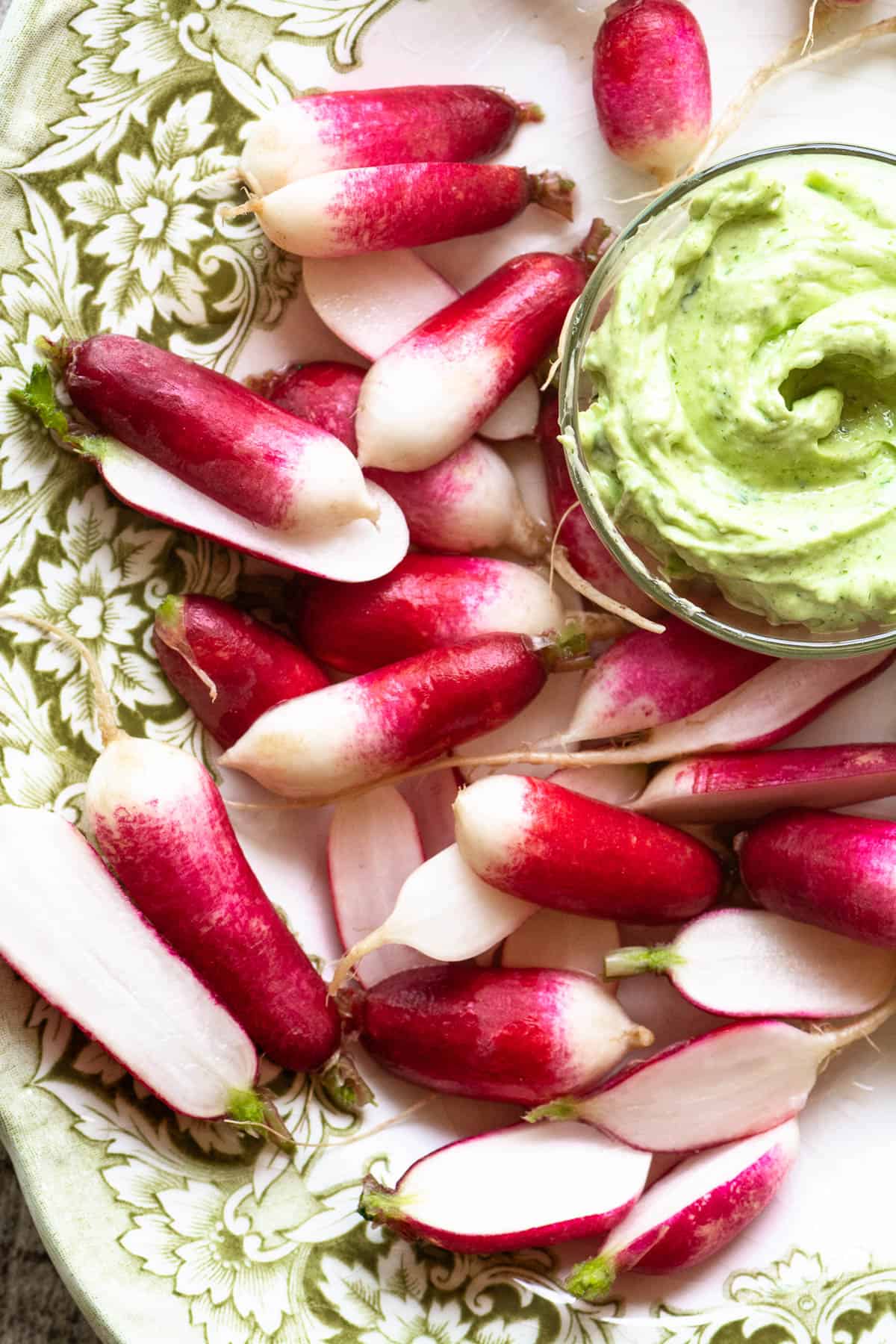 French breakfast radishes on a platter with tarragon butter for dipping.