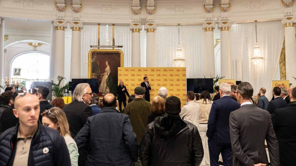 The award ceremony with the presenter on a small stage in a large room at the Negresco.