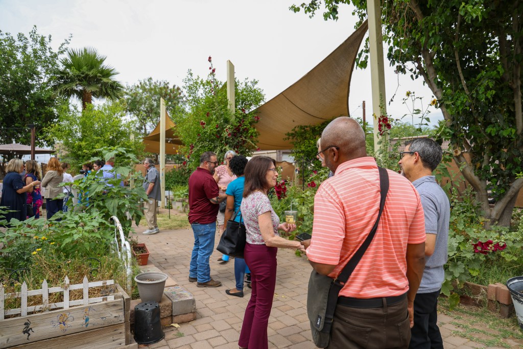 Community members tour the established side of Heart and Soil People’s Garden and on March 31, 2026, in Phoenix, Ariz.(Allison Kotzbauer/Cronkite News