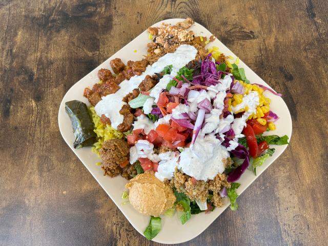 A Turkish mix bowl at Nazo’s Mediterranean Bowls & Salads, with half lettuce, half yellow rice and all the toppings.