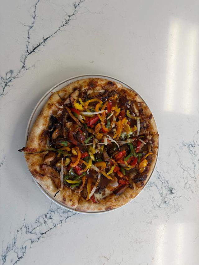 Flavaz Slice & Spice, 3306 Manatee Ave. W., recently opened in Bradenton, serving dishes like the jerk chicken and jerk pork pizza.