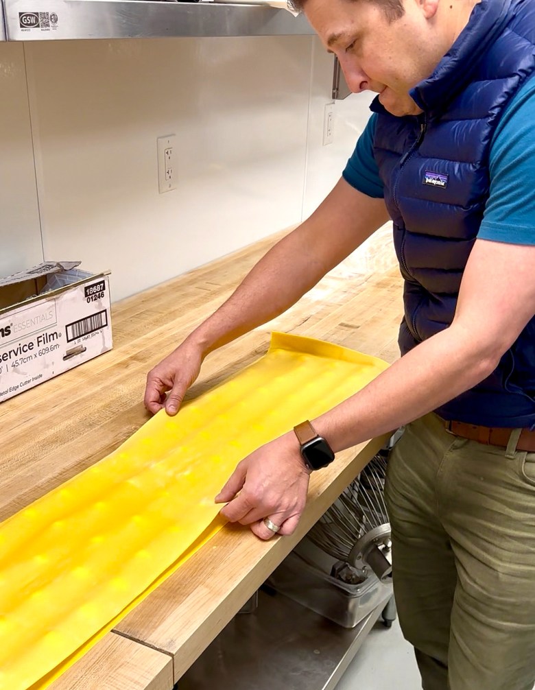 Jimmy Pardini applies ravioli dough in the kitchen at Willow Osteria.