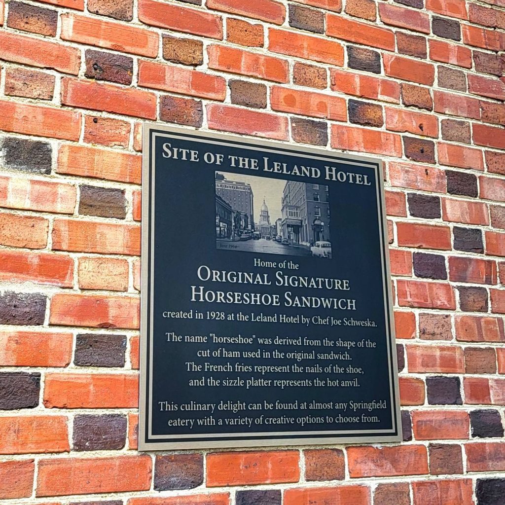 A plaque commemorating the origins of the horseshoe sandwich at the former Leland Hotel in Springfield.