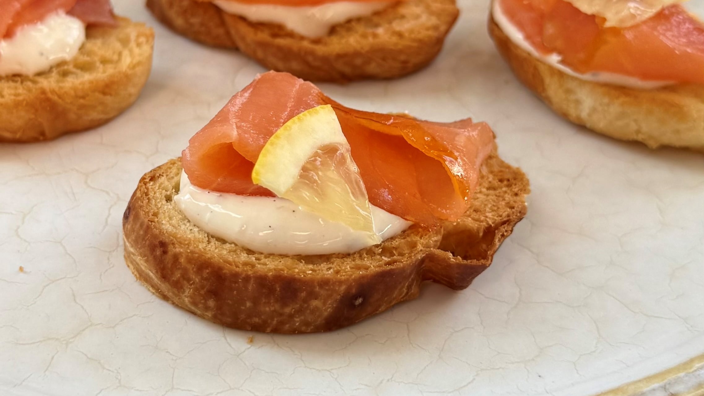 Smoked Salmon on Croissant Chips with Horseradish Black Pepper Cream and Lemon by Chef Paul Lillakas