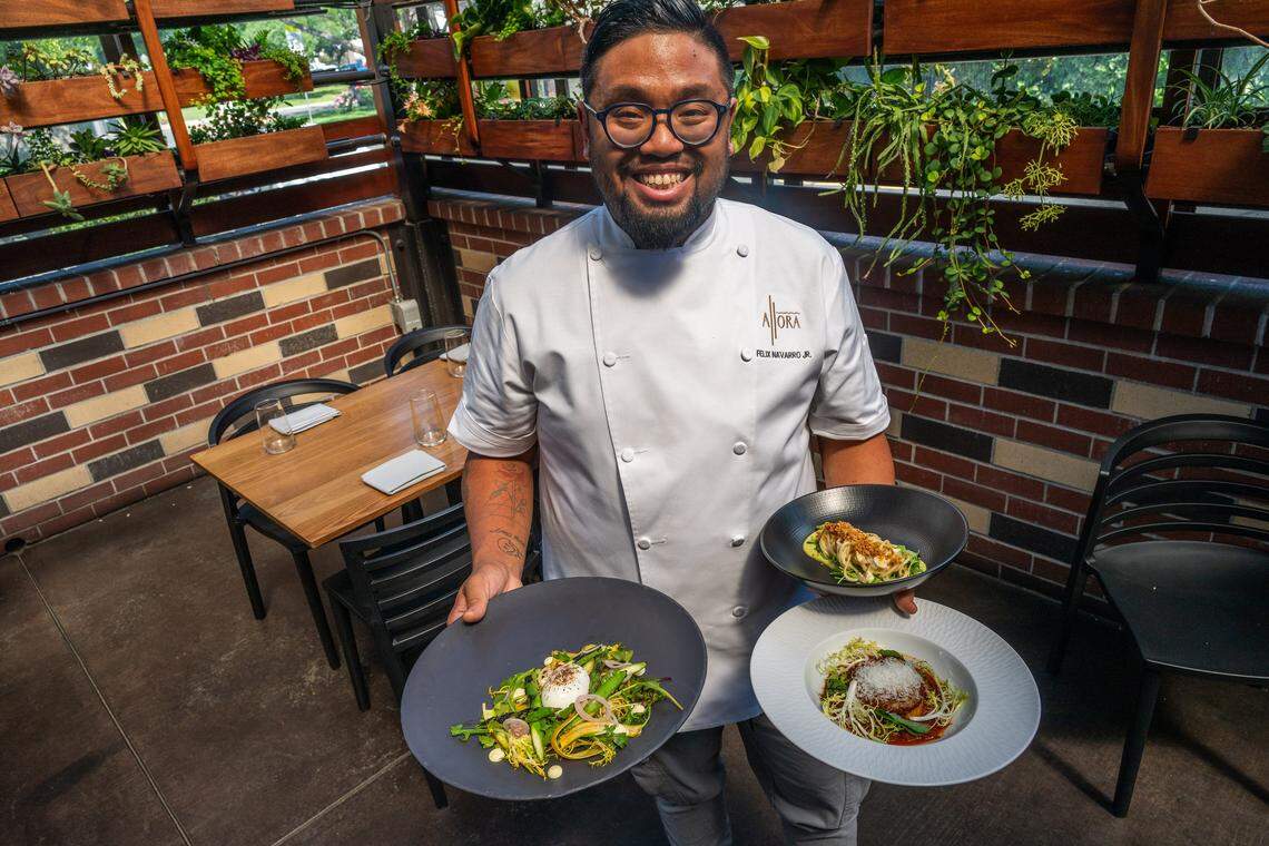 Sous chef Felix Navarro Jr. at Allora stands on the outdoor patio holding three dishes he prepared Tuesday, April 14, 2026, in East Sacramento. From left: insalata di asparagi with Delta asparagus, a six-minute egg and piquillo vinaigrette; gnocchi alla Romana with mushroom Bolognese, smoked scamorza and pecorino; and bucatini with green garlic puree, crispy artichoke and capers.