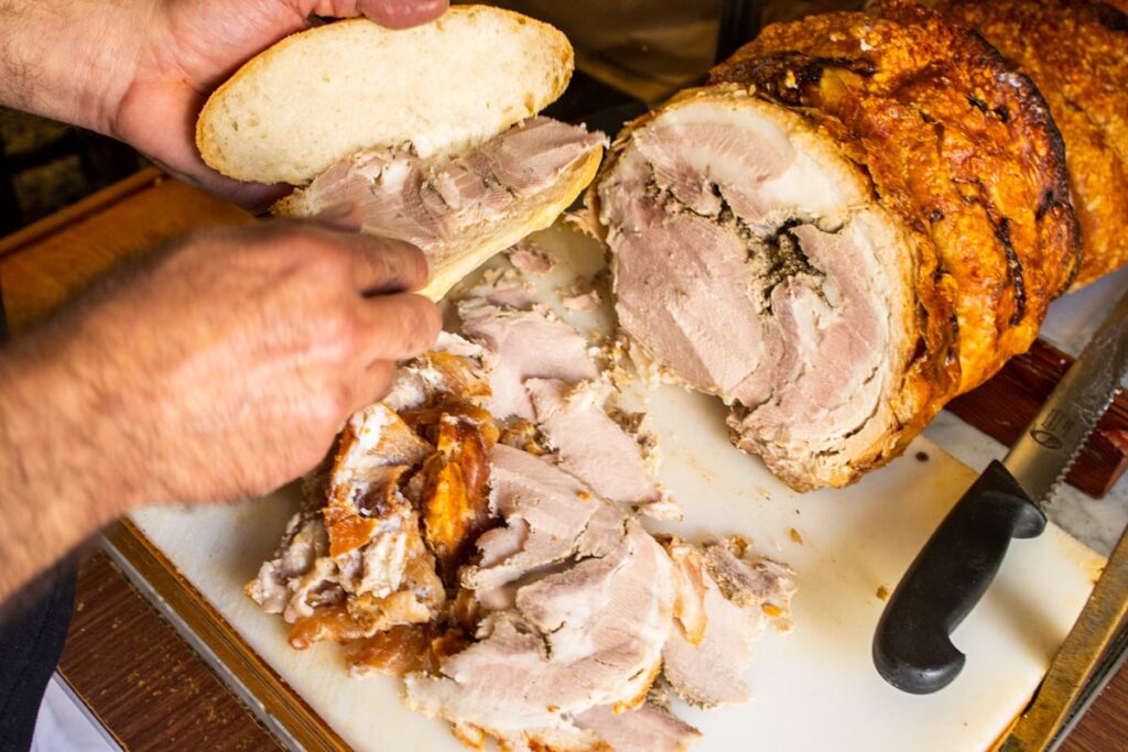 Slicing Porchetta at Er Buchetto in Rome