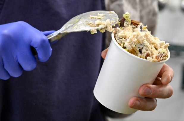 Hunter Verhulst fills a pint of Turtle Frownie at Sadboy Creamery in Denver on Tuesday, April 14, 2026. (Photo by AAron Ontiveroz/The Denver Post)
