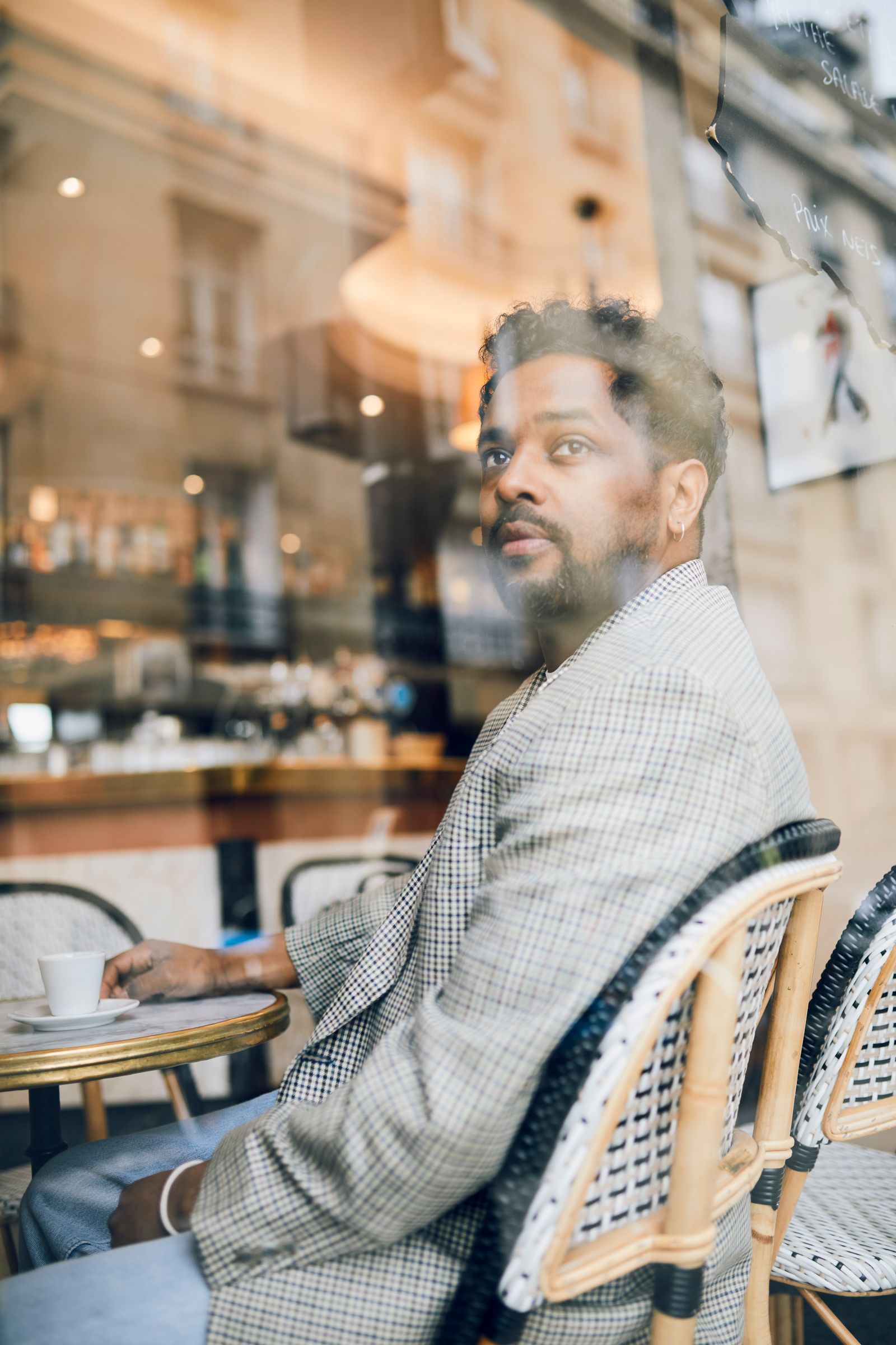 Image may contain Person Sitting Adult Face Head Hair and Black Hair