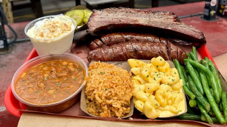 A tray of barbecue meats with sides at Terry Black's Barbecue