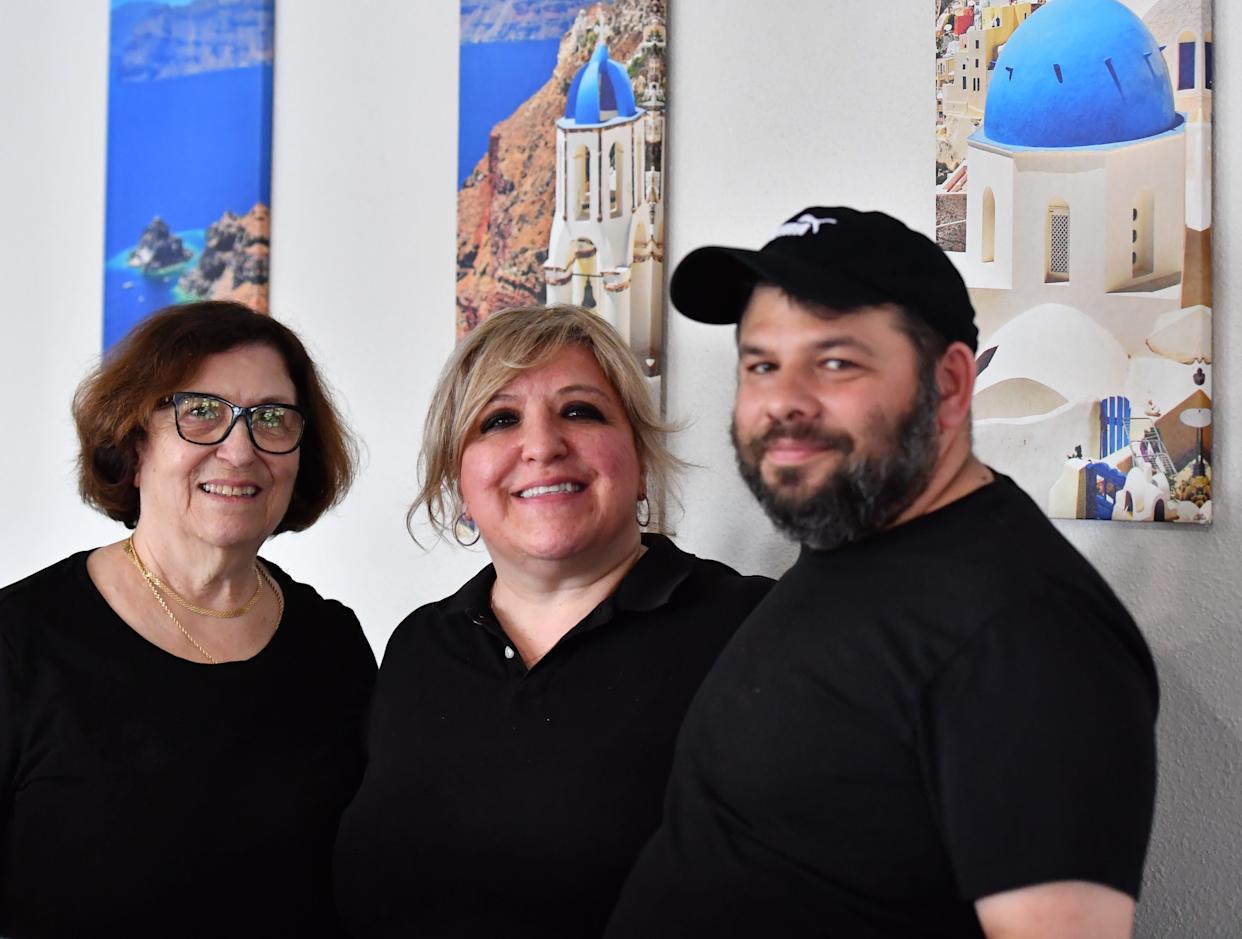 Stella Panagiotarakos (left), the owner of Hibiscus Cafe, her daughter Mary Akriotis (middle), and Michail Akriotis (right), who is Mary's husband, pose for a picture inside Hibiscus Cafe on April 9. The family-owned restaurant specializes in Greek cuisine and is located at 4114 Burkburnett Road, Suite No. 6, in Wichita Falls.
