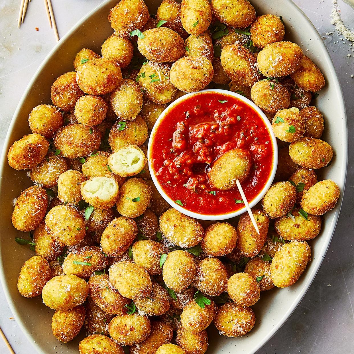 fried gnocchi bites in a bowl with marinara sauce on the side