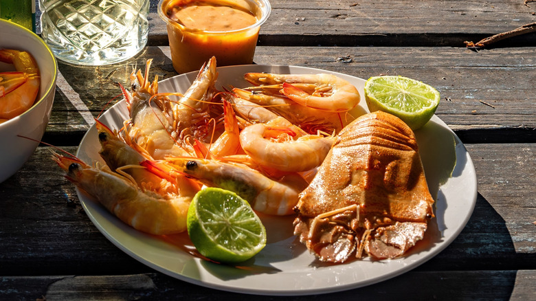 A plate of cooked prawns and lobster tail at a restaurant in Australia