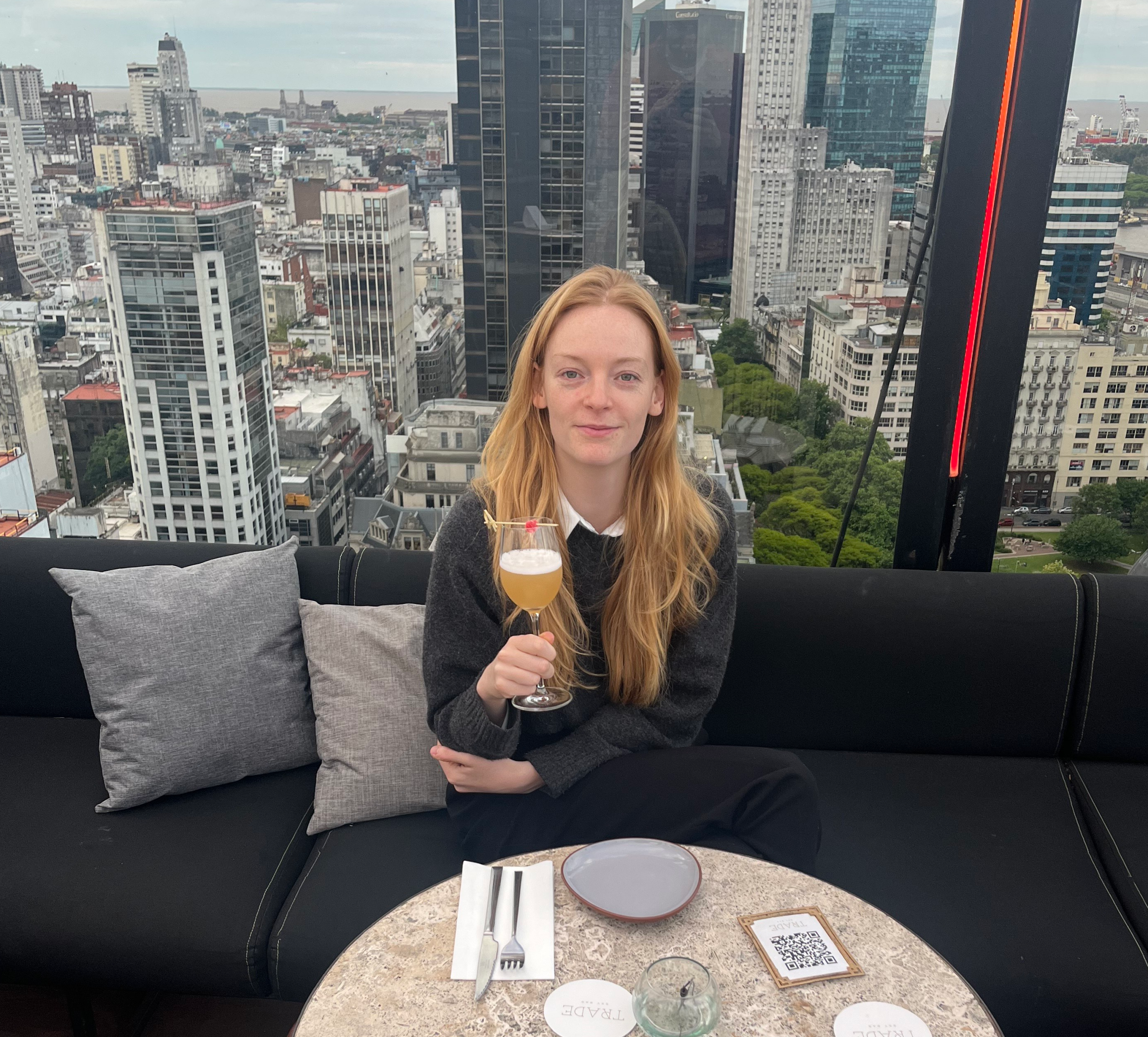 Charlotte Ivers enjoying a drink with the Buenos Aires skyline in the background.