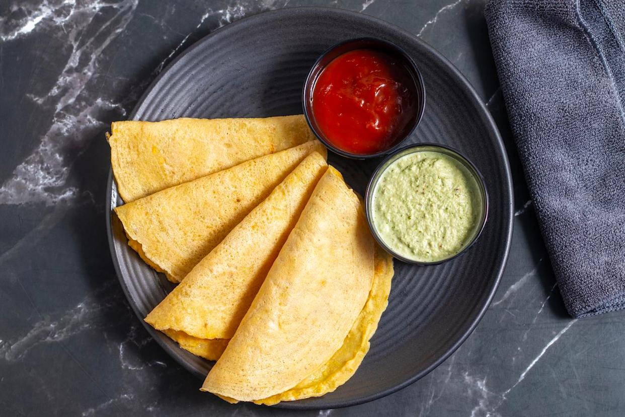 Moong dal chilla is an Indian pancake made from ground mung beans, typically enjoyed as a quick, protein- and fiber-rich breakfast or snack across North India.Credit: im a photographer and an artist / Getty Images