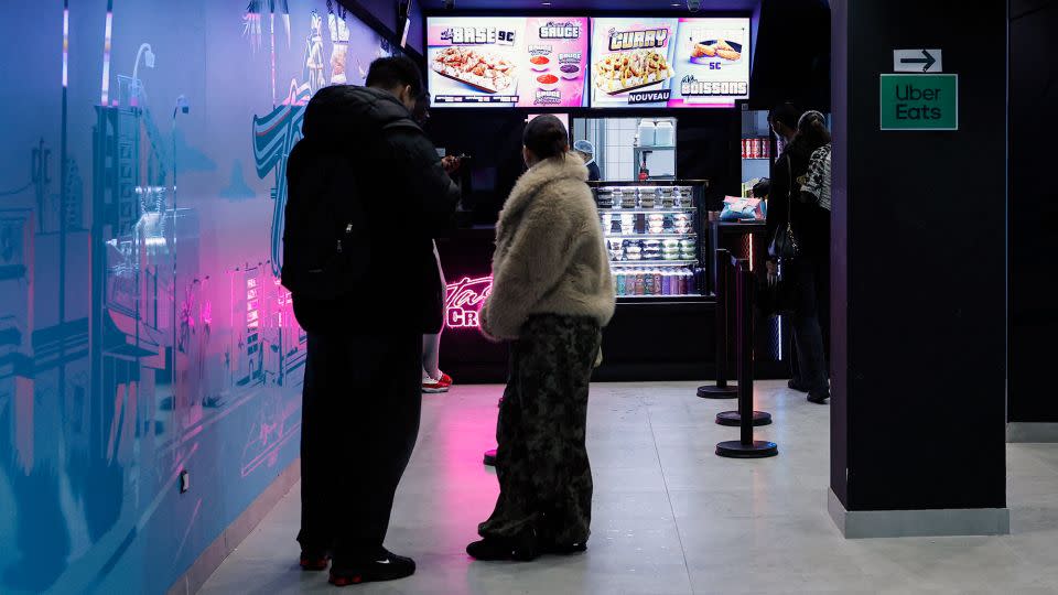 Customers stand in line at a Tasty Crousty fast food restaurant in Paris. The chain, which serves chicken over rice with flavorful sauces, is part of a surge in popularity among fast food restaurants in France. - Charlotte Siemon/AFP/Getty Images