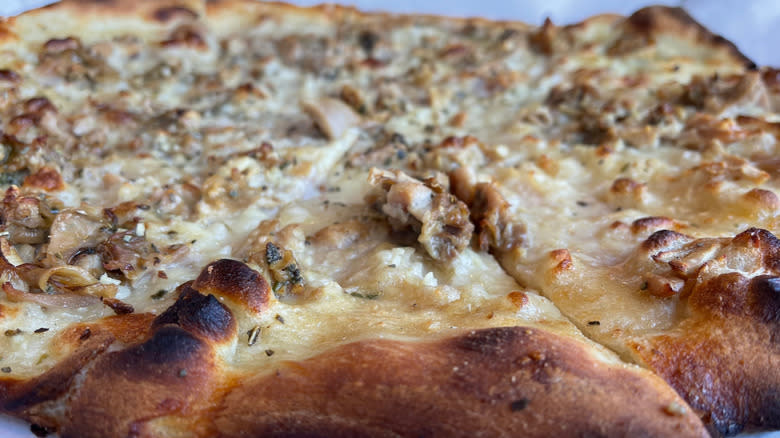 A closeup of white clam pizza