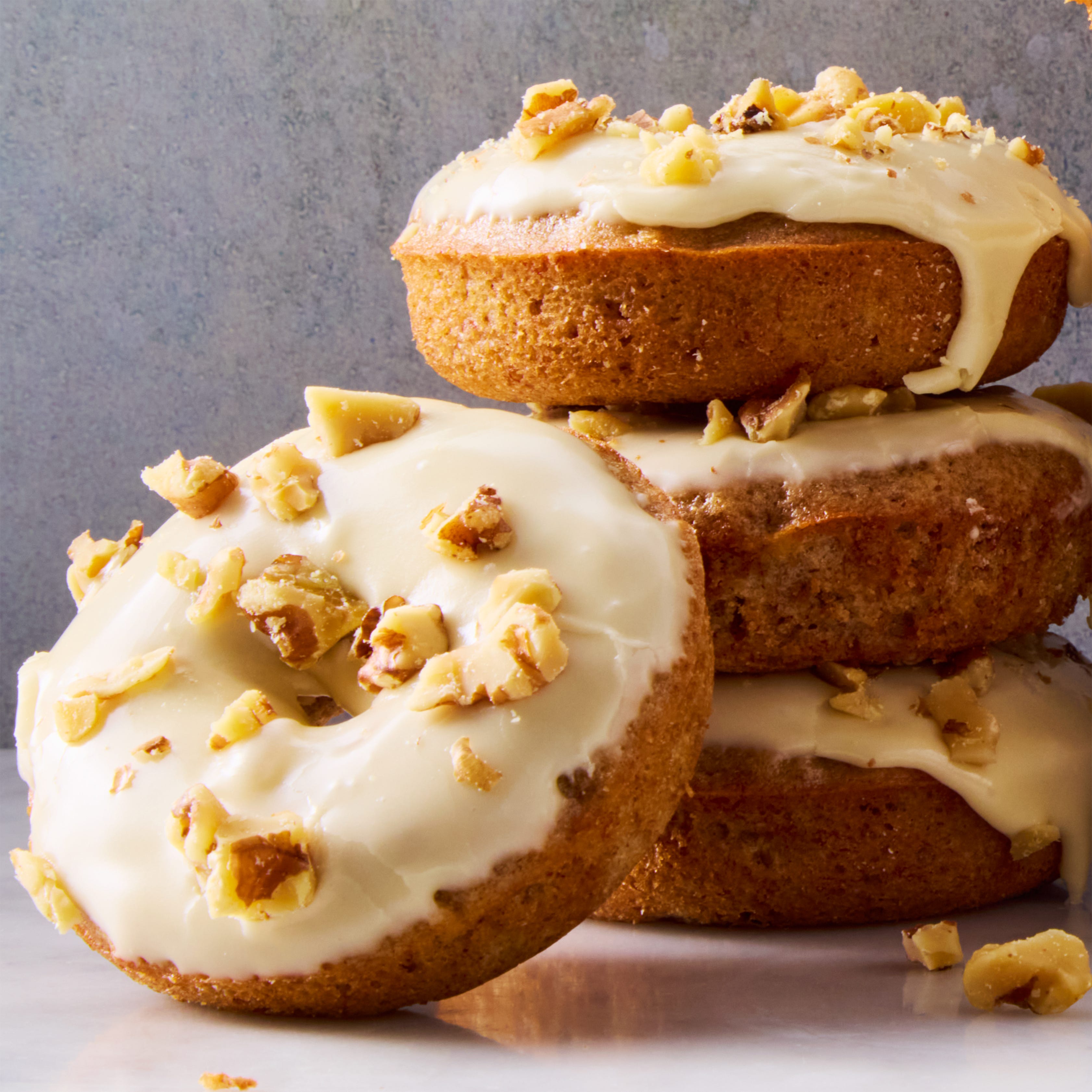 banana bread donuts topped with maple glaze and chopped walnuts