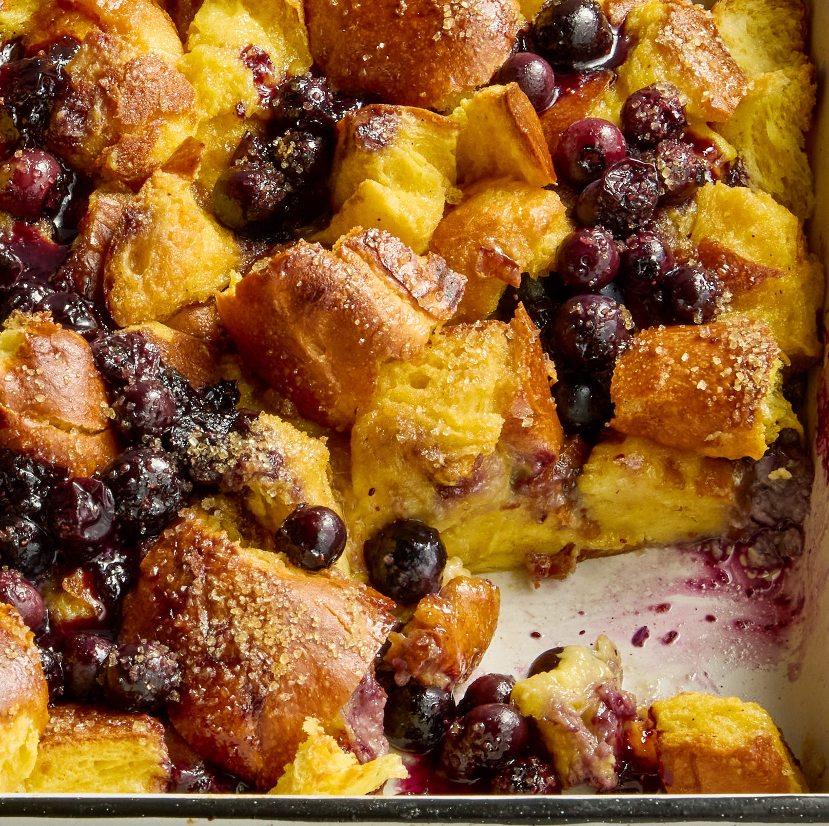 french toast casserole in a pan with blueberries