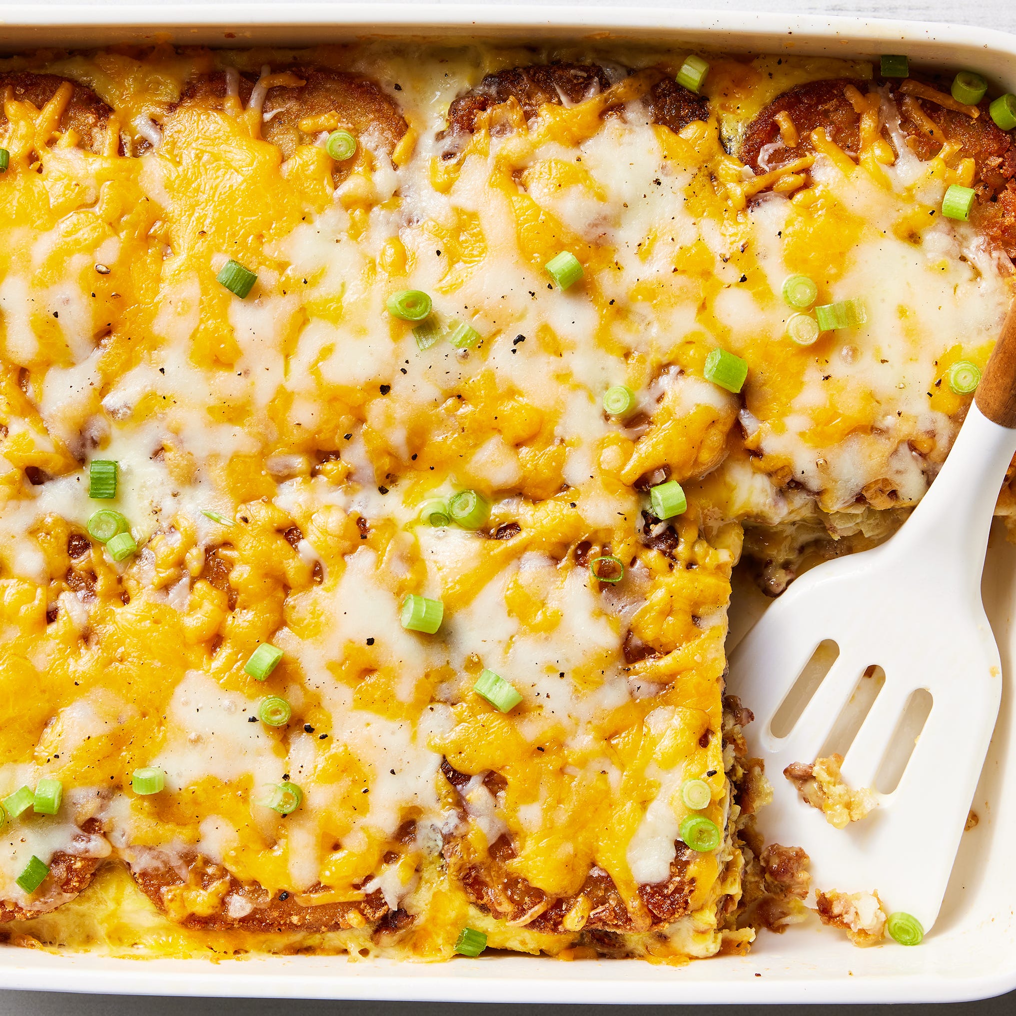 layered hashbrowns, eggs, and sausage topped with cheese and baked in a casserole dish